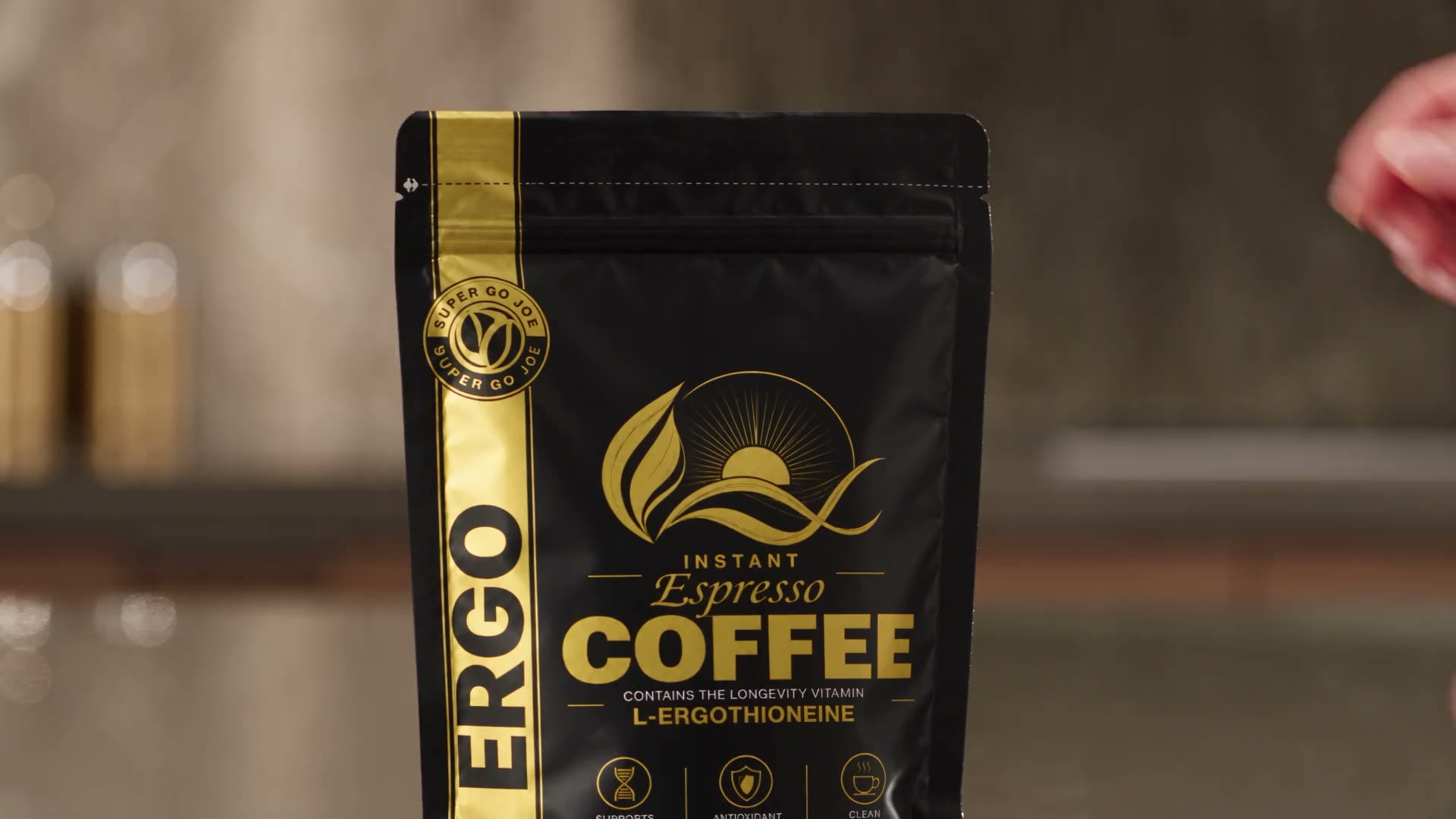 Hands opening a black pouch of instant espresso coffee on a kitchen counter